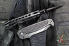 Half Face Blades- Disaster Folder/Flipper- Button Lock- Anodized Black Monolithic Aluminum Handle- Dimpled Grip- Black Nitride S45VN Blade- Deep Carry Clip